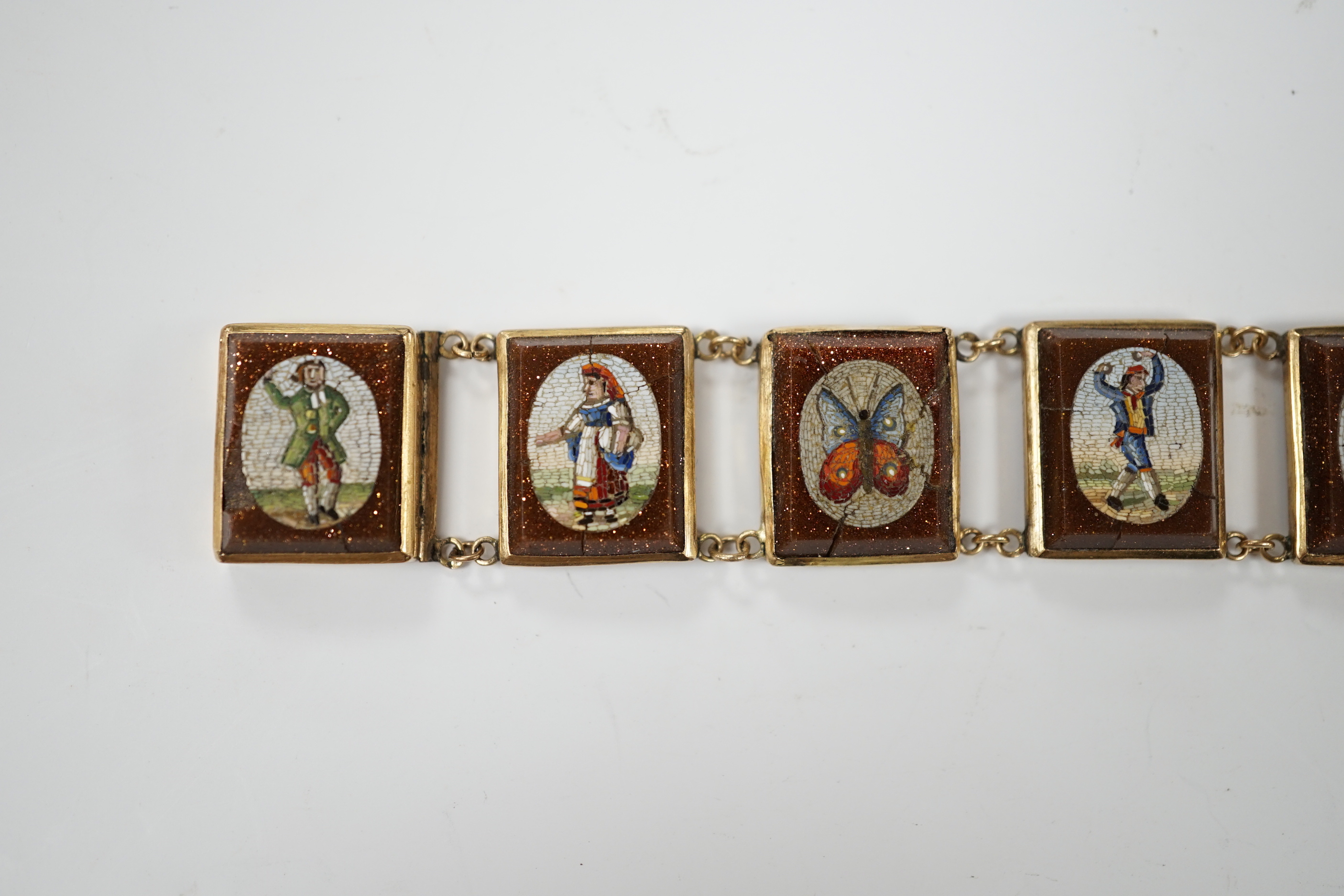 An Italian yellow metal, micro mosaic and goldstone set bracelet, with panels of Italian figures and insects, 17.3cm, gross weight 15.6 grams